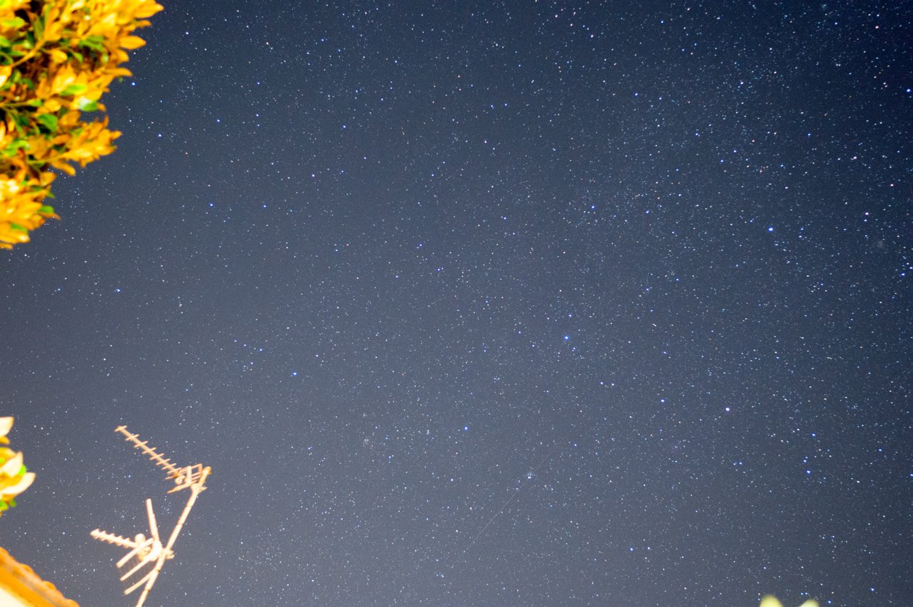 A pair of high-quality astronomy binoculars against a starry night sky, perfect for observing constellations, nebulae, and galaxies